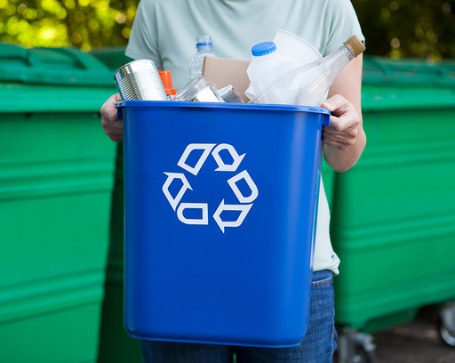 man carrying recycling bin out for pick up.